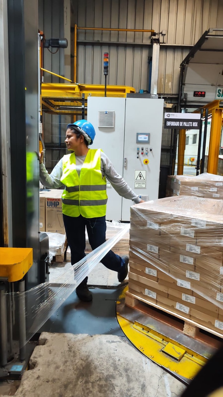 Operaria de United Continents en el área de enfundado de pallets